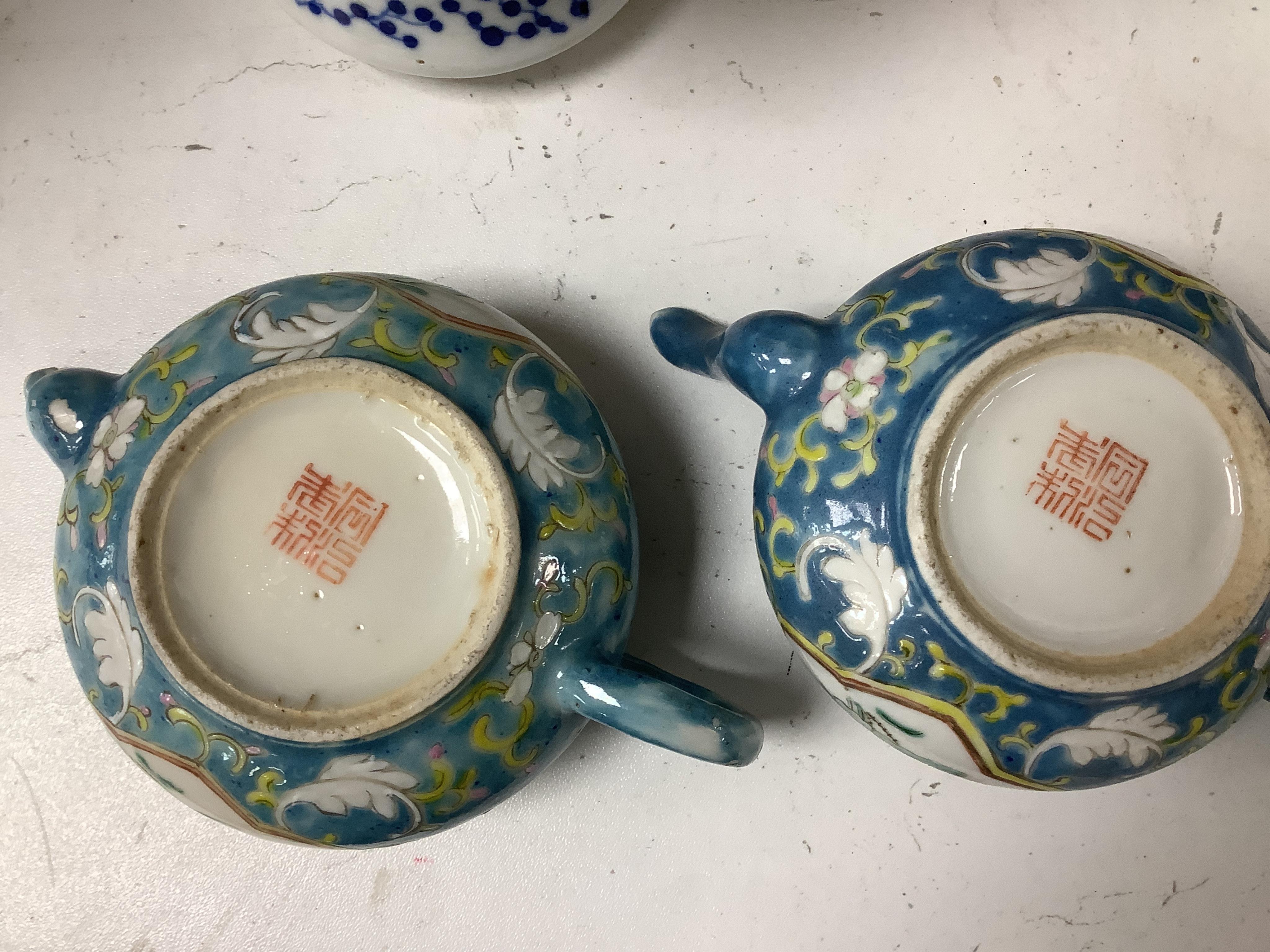 Two Chinese blue ground teapots, Tongzhi mark, and a pair of orange ground bowls and covers, teapots 15cm wide. Condition - fair